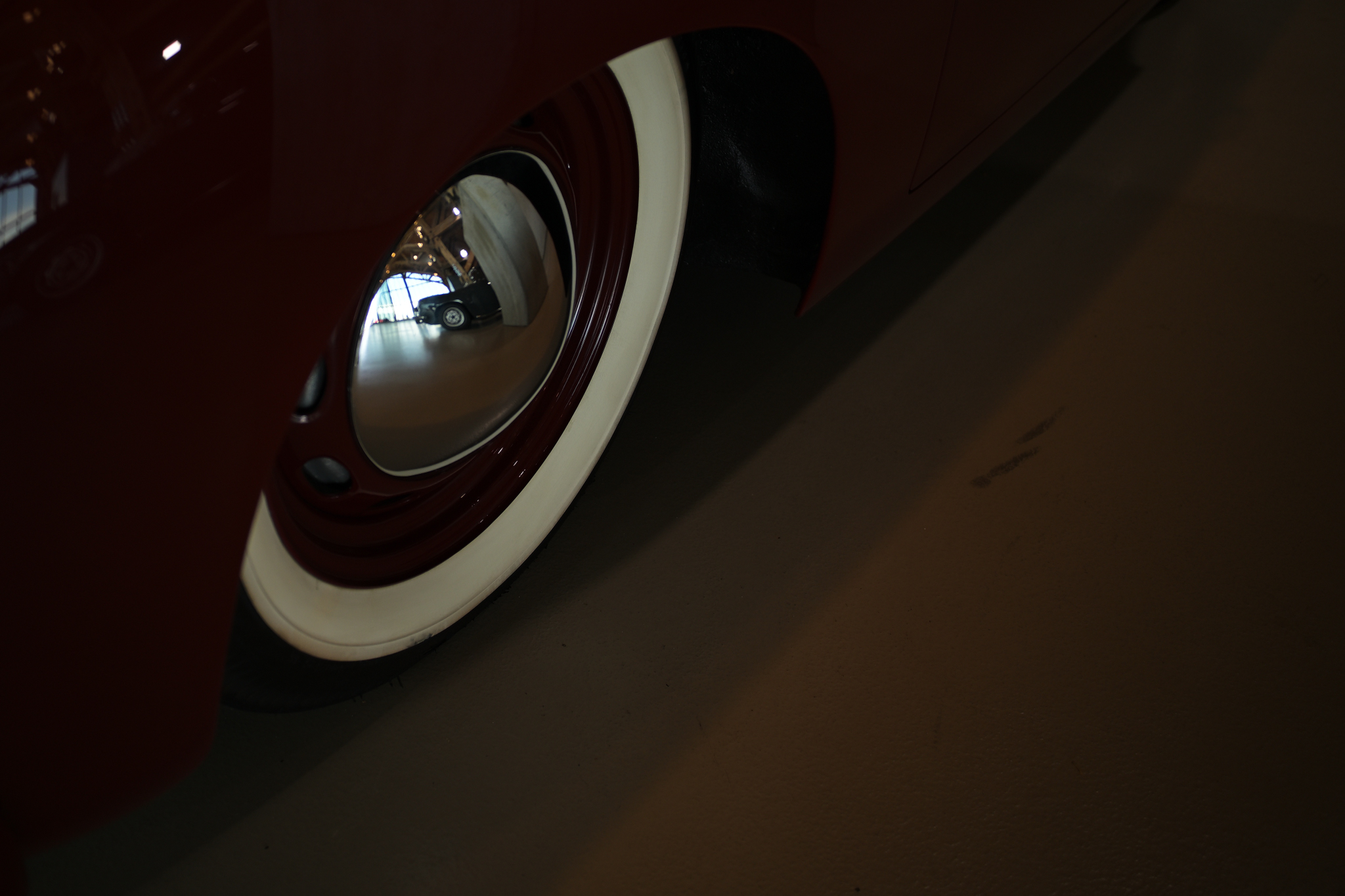 Reflection in hub cap brown car